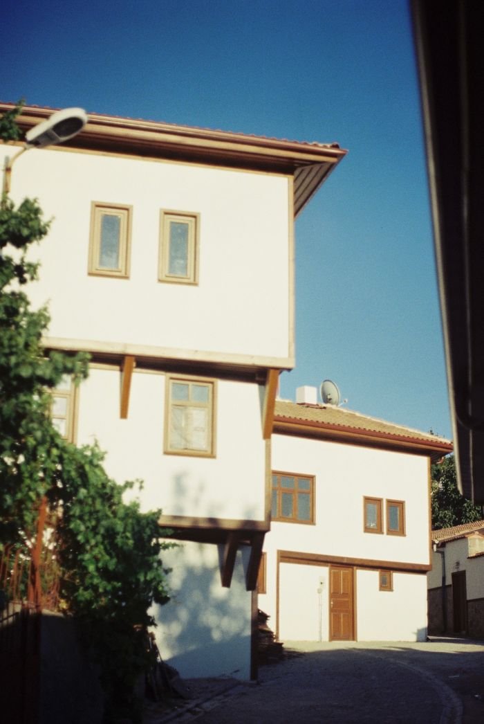 service-02 Traditional house exterior under clear blue sky, showcasing architectural details.