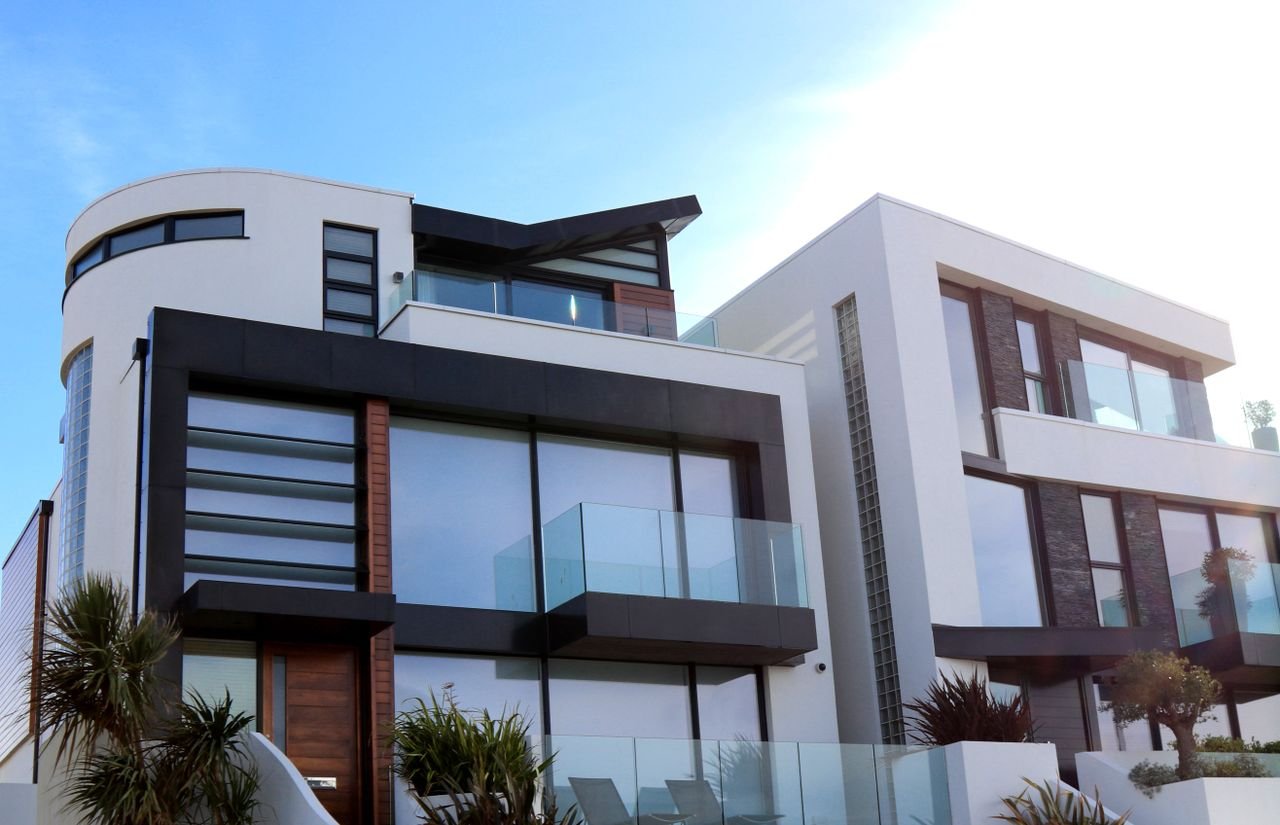 Mastering the First Impression: Your intriguing post title goes here Contemporary luxury home with glass balconies in Poole, UK, showcasing modern architectural design.